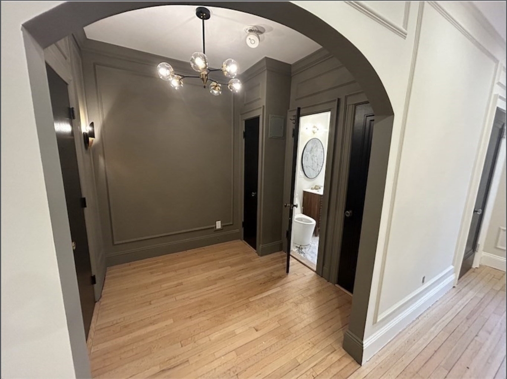4 Chiswick Road, Unit 34 Boston, MA 02135 - Photo 8 of 10 a view of a hallway with wooden floor and staircase