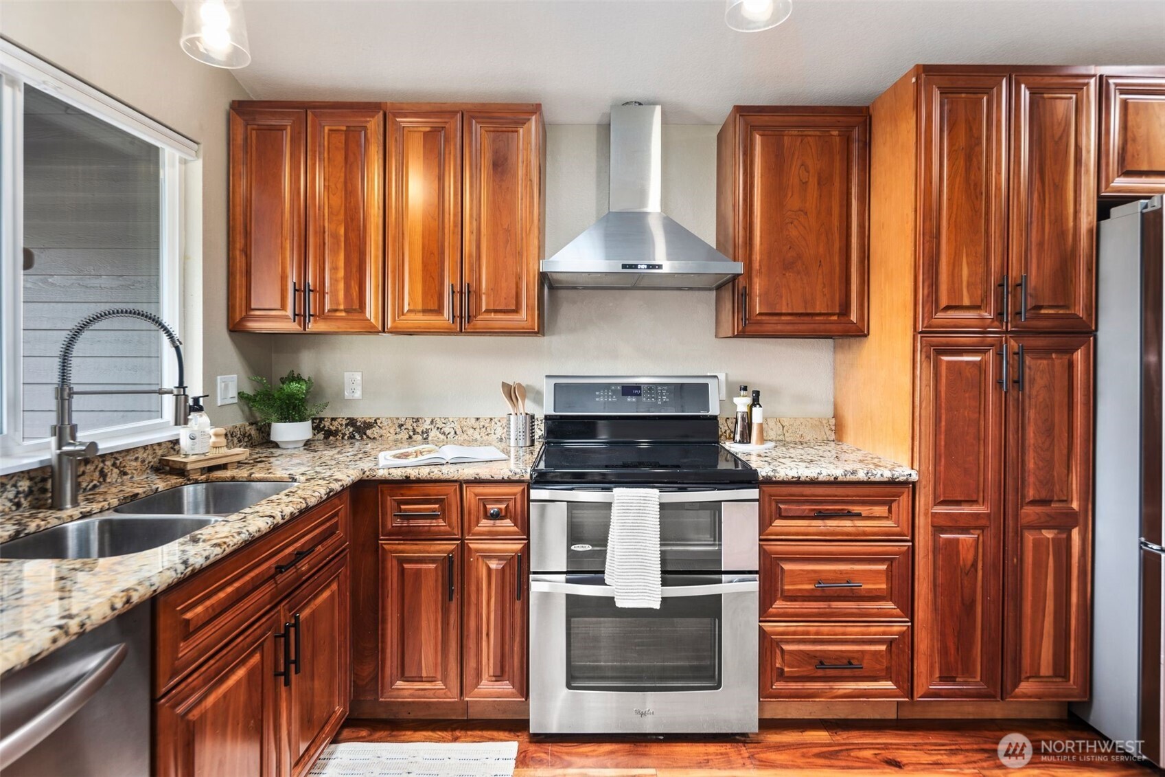 22707 14th Place West Bothell, WA 98021 - Photo 13 of 39 a kitchen with stainless steel appliances granite countertop a stove a sink dishwasher and a refrigerator