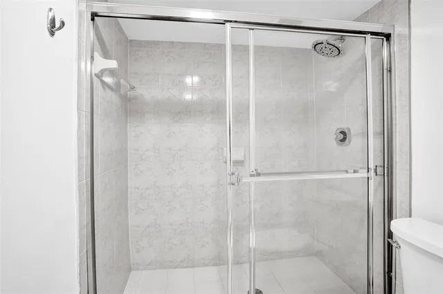 a bathroom with a glass shower door