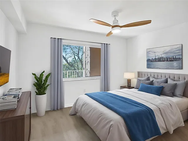 a spacious bedroom with a bed and a window