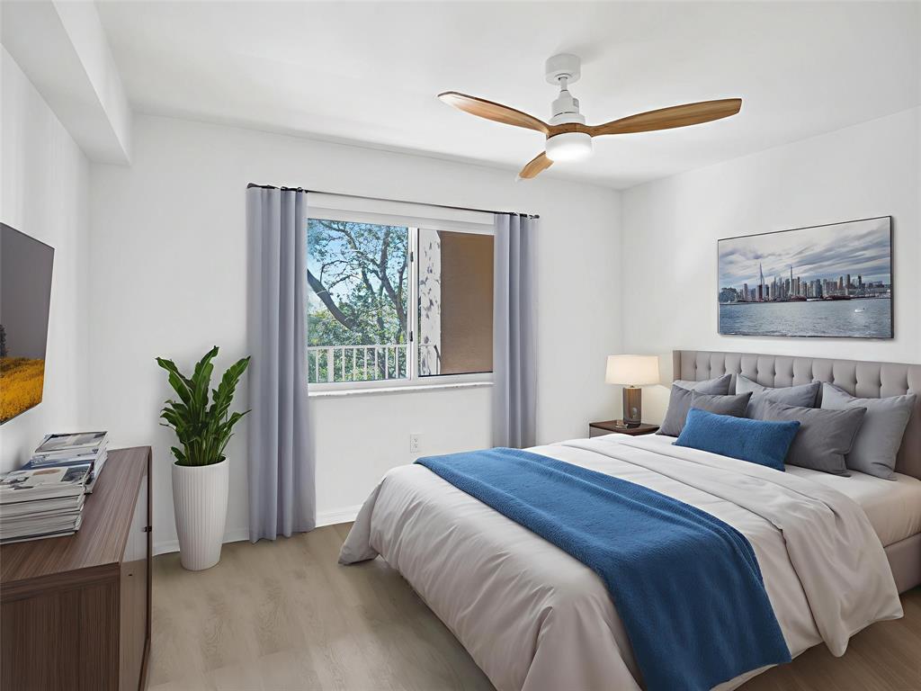 9470 Tangerine Place, Unit 404 Davie, FL 33324 - Photo 12 of 39 a spacious bedroom with a bed and a window