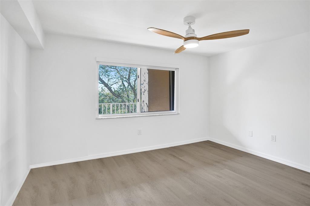 9470 Tangerine Place, Unit 404 Davie, FL 33324 - Photo 15 of 39 an empty room with a window and a ceiling fan