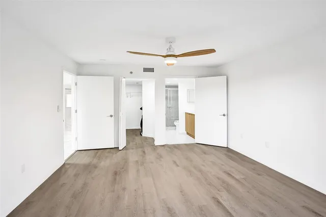 a view of an empty room with wooden floor