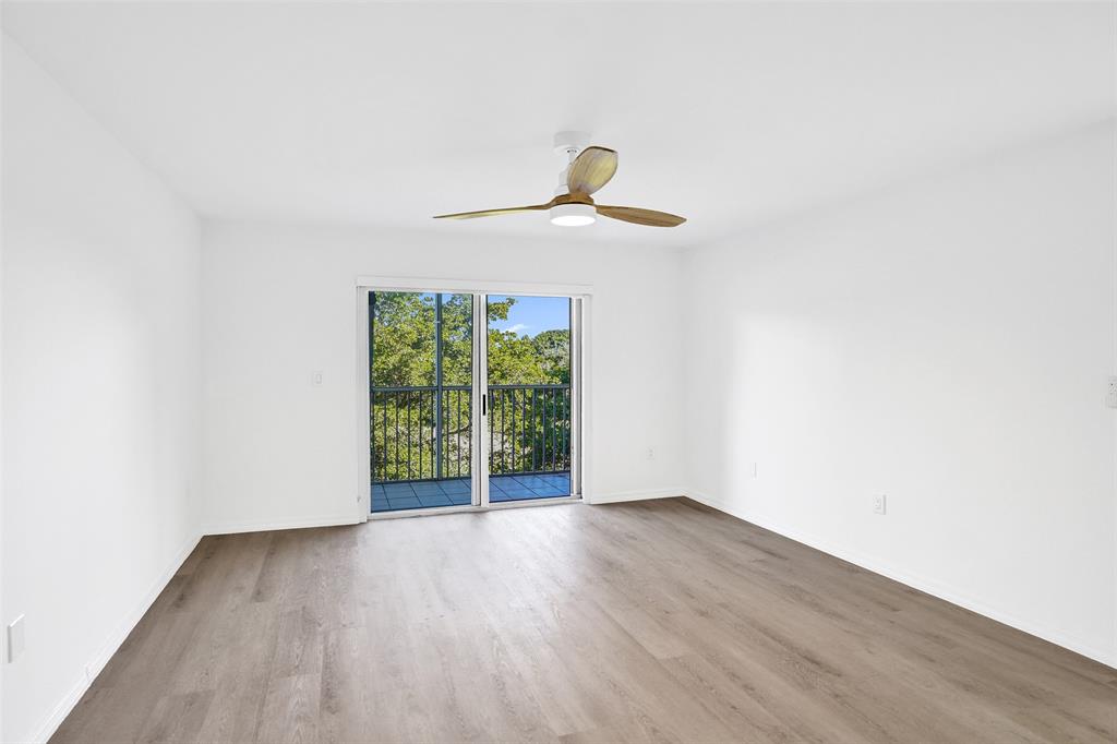 9470 Tangerine Place, Unit 404 Davie, FL 33324 - Photo 22 of 39 a view of an empty room with wooden floor and a window