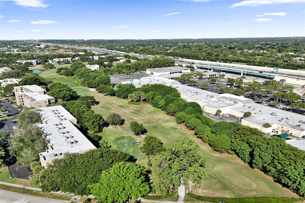 9470 Tangerine Place, Unit 404 Davie, FL 33324 - Photo 29 of 39 an aerial view of a city with lots of residential buildings ocean and mountain view in back