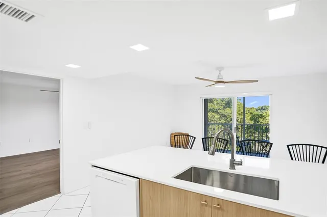 a kitchen with a sink and a refrigerator