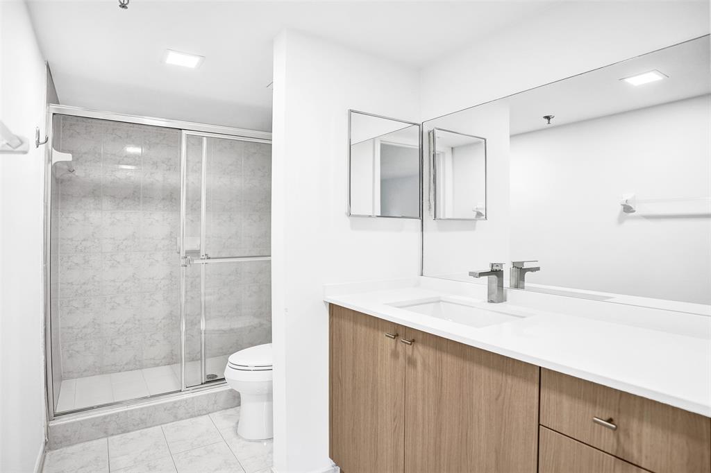 9470 Tangerine Place, Unit 404 Davie, FL 33324 - Photo 10 of 39 a bathroom with a sink a toilet and shower