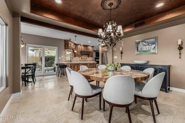 a dining room with furniture a chandelier and window