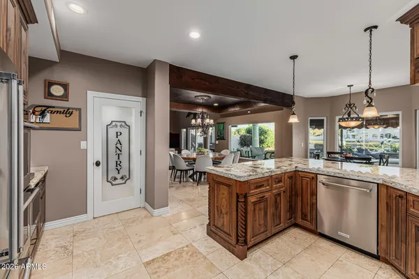 a kitchen with a sink a counter space appliances and cabinets