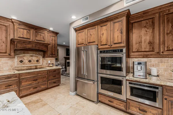 a kitchen with wooden cabinets and a stove top oven
