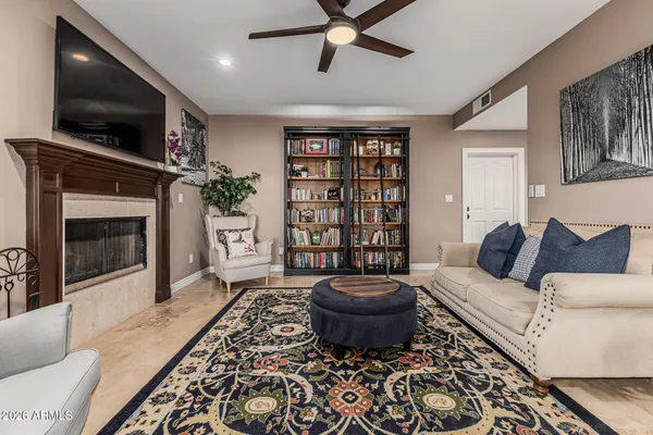 a living room with furniture and a fireplace