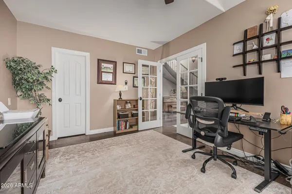 a view of a workspace with furniture and a bedroom