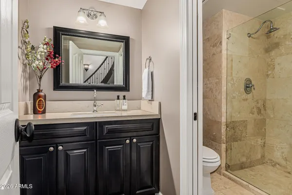 a bathroom with a sink vanity and a mirror