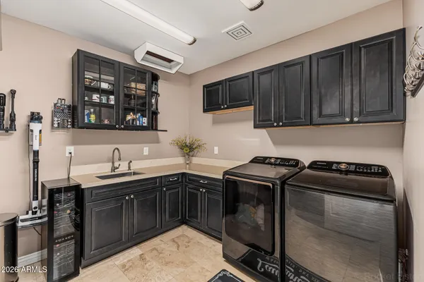 a kitchen with a sink stove and cabinets