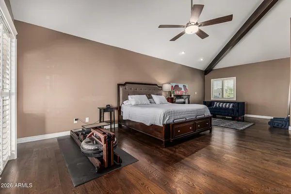 a bedroom with a bed chandelier and a window