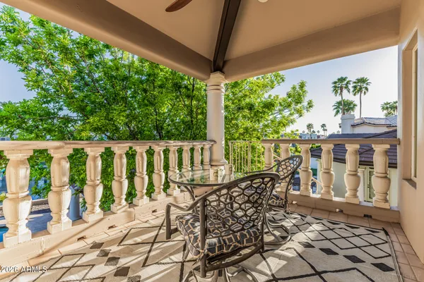 a balcony with wooden floor and fence