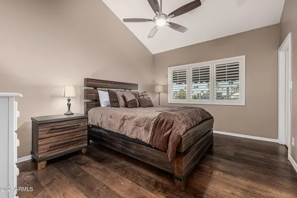 a bed sitting in a bedroom next to a window