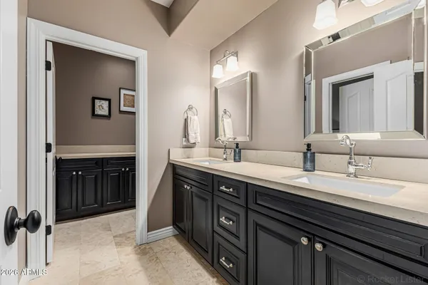 a spacious bathroom with a double vanity sink a and mirror