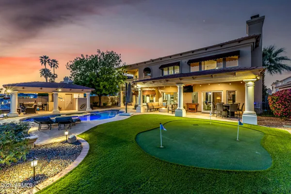 a view of a house with swimming pool and sitting area