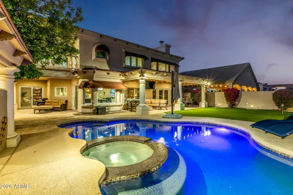a swimming pool with outdoor seating and yard