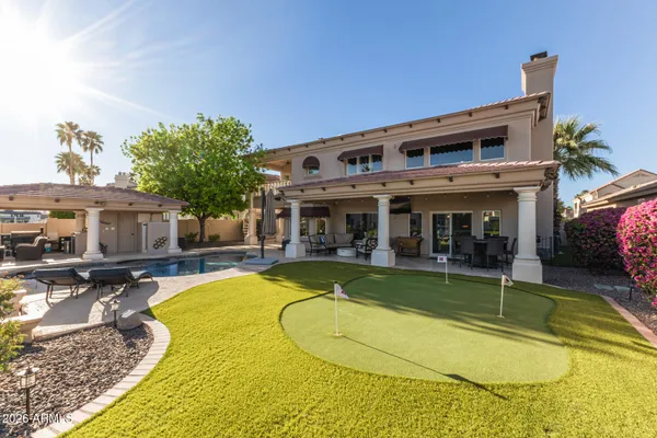 a view of a house with swimming pool and sitting area