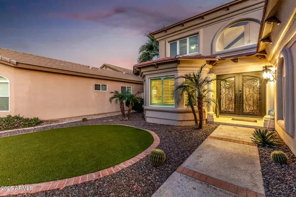 a view of a house with a swimming pool and sitting area