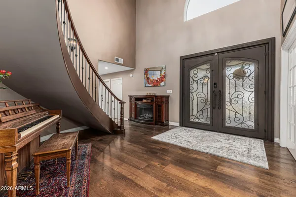 a view of entryway and hall with wooden floor
