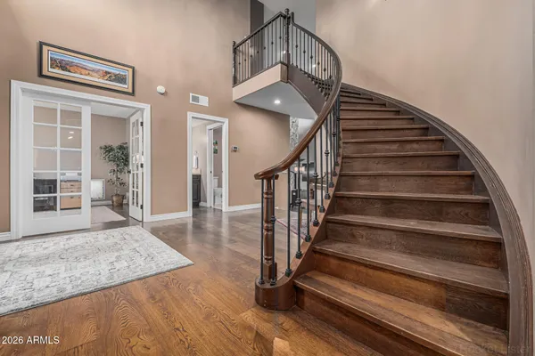 a view of entryway and hall with wooden floor