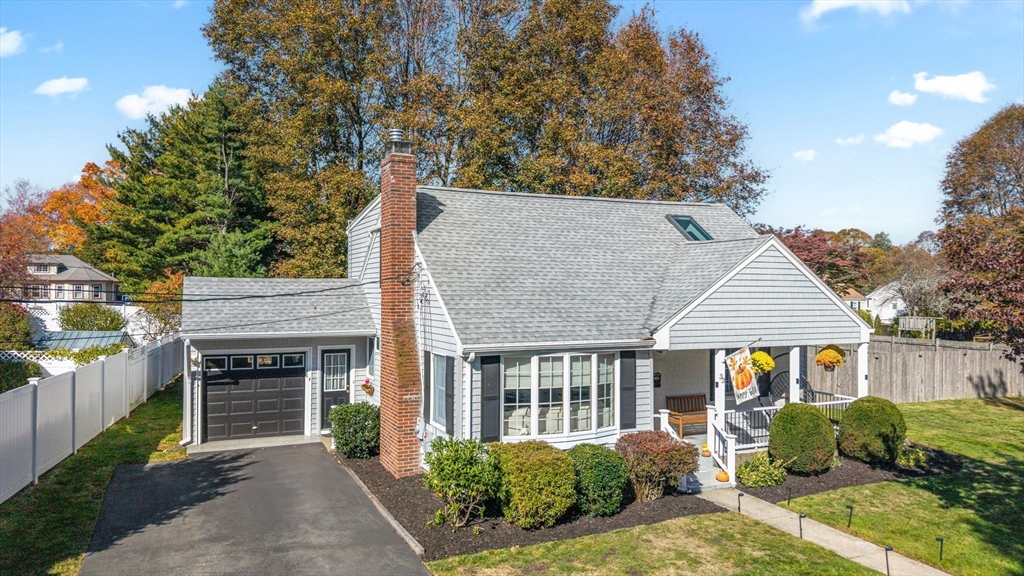a view of a house with a yard and potted plants
