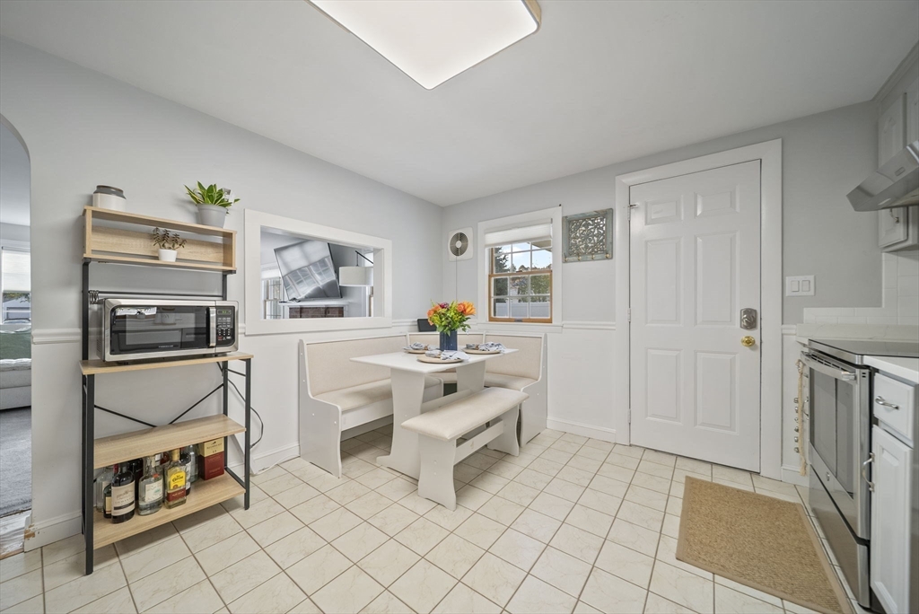 33 Ritchie Road Lynn, MA 01904 - Photo 12 of 39 a living room with furniture a flat screen tv and a refrigerator