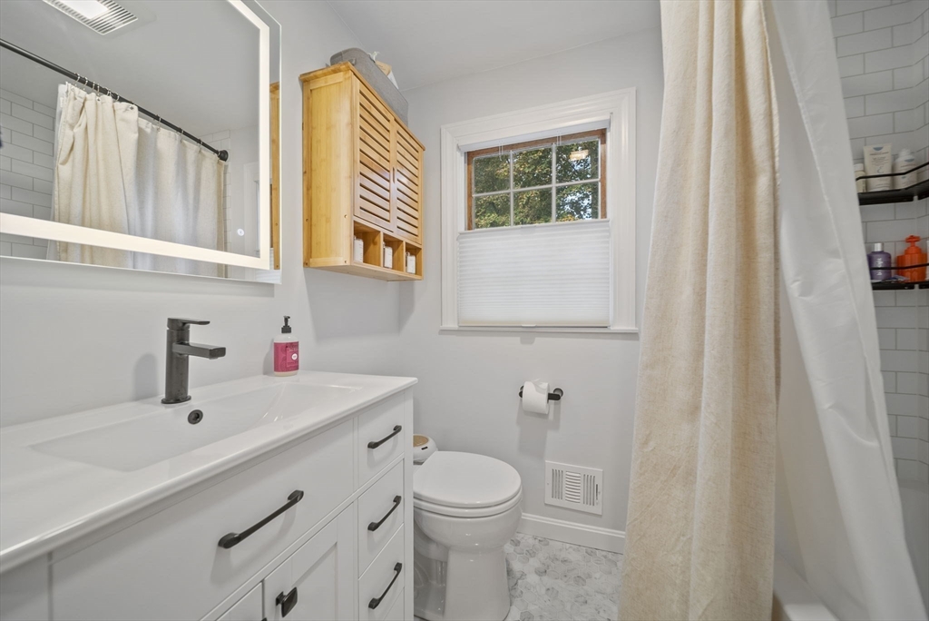 33 Ritchie Road Lynn, MA 01904 - Photo 16 of 39 a bathroom with a sink a toilet and a mirror