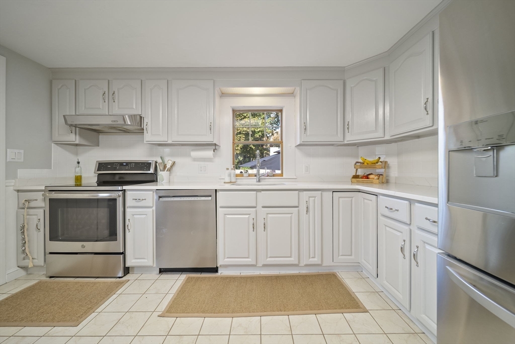 33 Ritchie Road Lynn, MA 01904 - Photo 8 of 39 a kitchen with white cabinets and white appliances