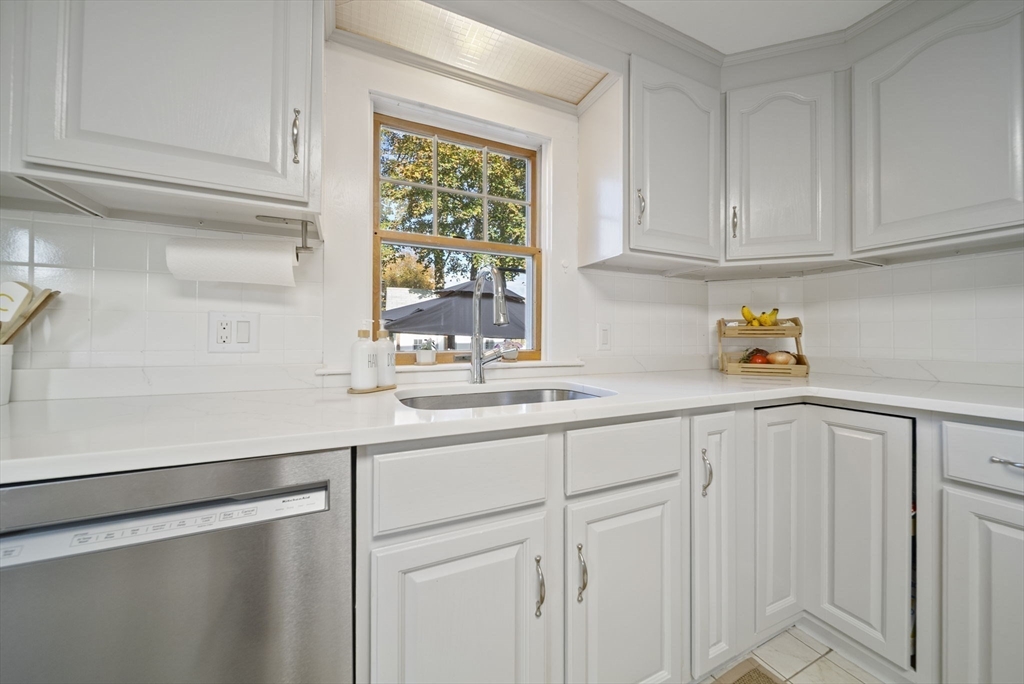 33 Ritchie Road Lynn, MA 01904 - Photo 9 of 39 a kitchen with white cabinets and sink