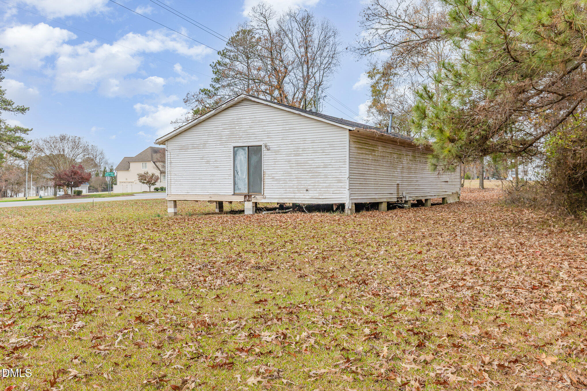 6801 Rock Service Station Road Raleigh, NC 27603 - Photo 36 of 36 a backyard of a house with lots of green space