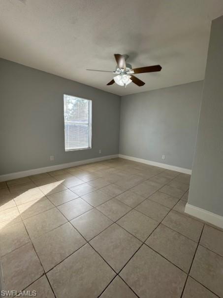 2964 Francis Avenue, Unit 13 Naples, FL 34112 - Photo 4 of 5 Spare room with a textured ceiling, a ceiling fan, and light tile patterned floors