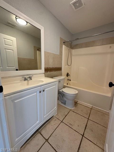 2964 Francis Avenue, Unit 13 Naples, FL 34112 - Photo 5 of 5 Full bath with vanity, bathing tub / shower combination, a textured wall, a textured ceiling, and light tile patterned flooring