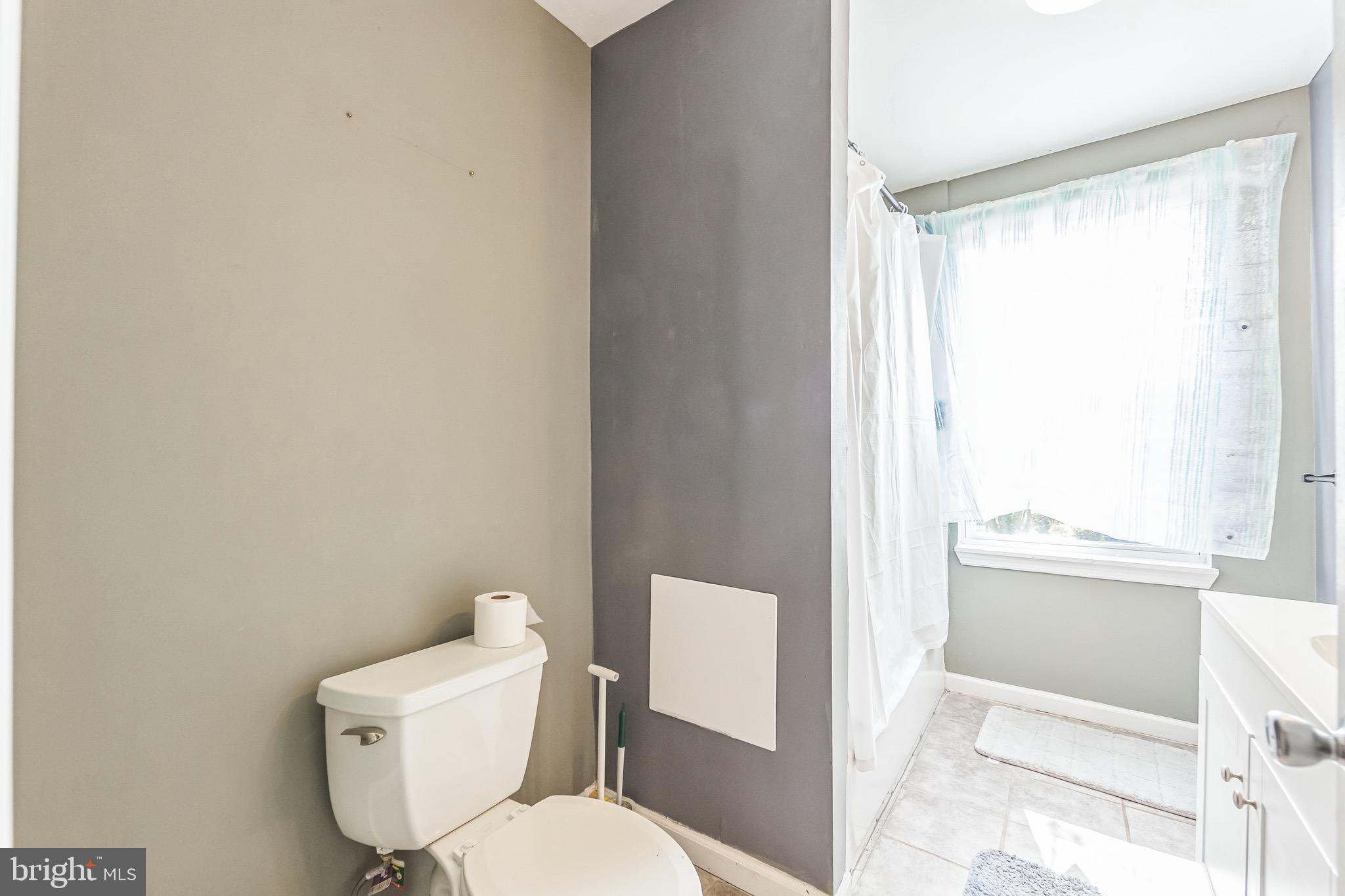 112 Norris Street Mantua, NJ 08051 - Photo 11 of 25 a white toilet sitting next to a bathroom sink