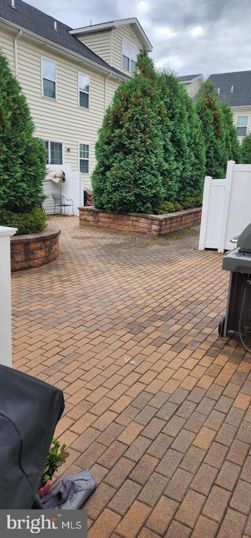 3753 Jacob Stout Road, Unit 12 Doylestown, PA 18902 - Photo 11 of 13 Charming brick patio with lush greenery.