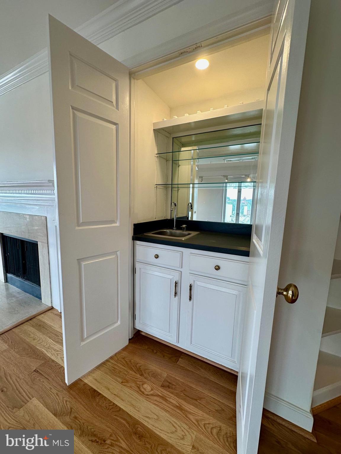 1080 Wisconsin Avenue Northwest, Unit 503W Washington, DC 20007 - Photo 13 of 36 a kitchen with a sink and a mirror