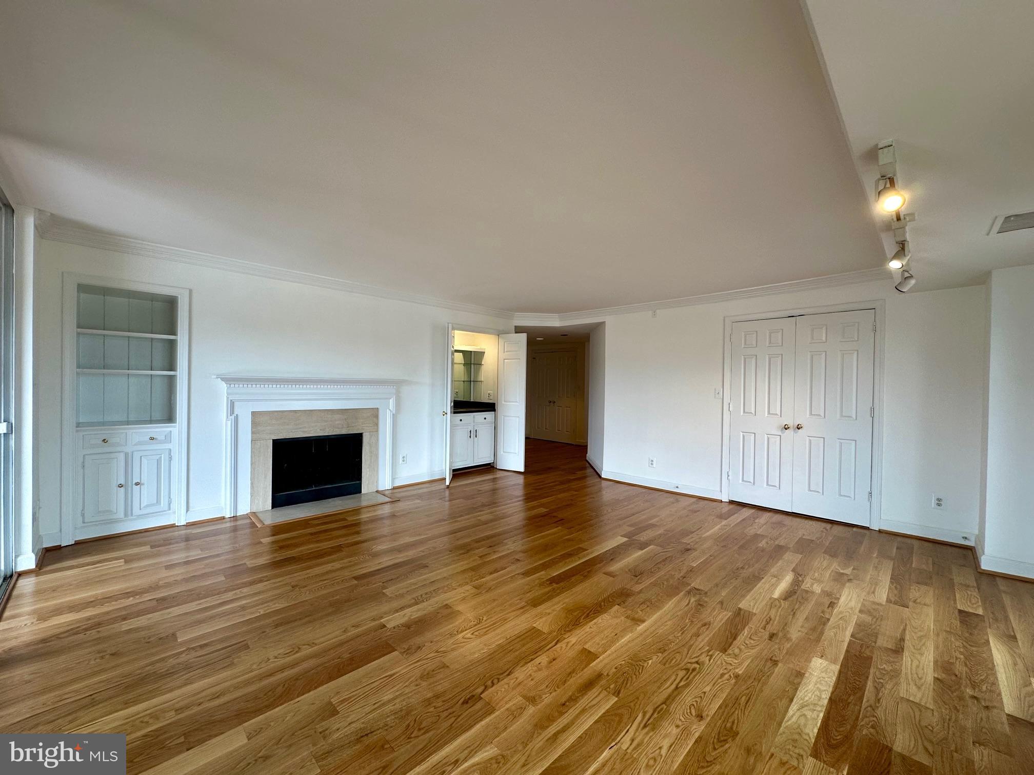 1080 Wisconsin Avenue Northwest, Unit 503W Washington, DC 20007 - Photo 14 of 36 a view of empty room with wooden floor and fireplace