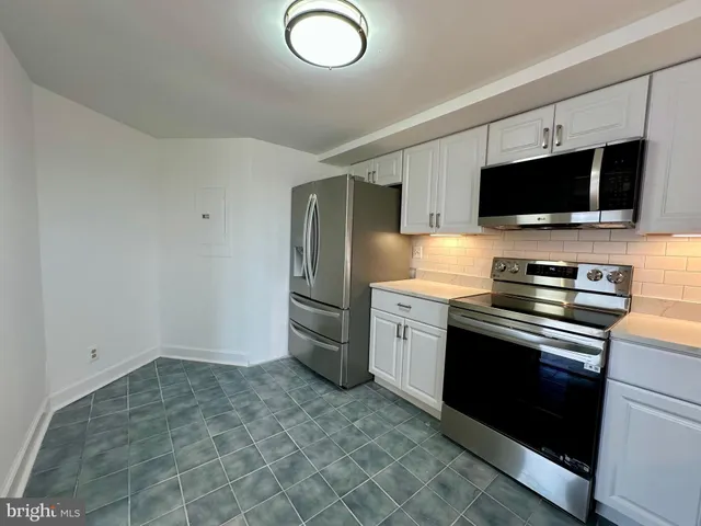 a view of empty room with wooden floor and fireplace