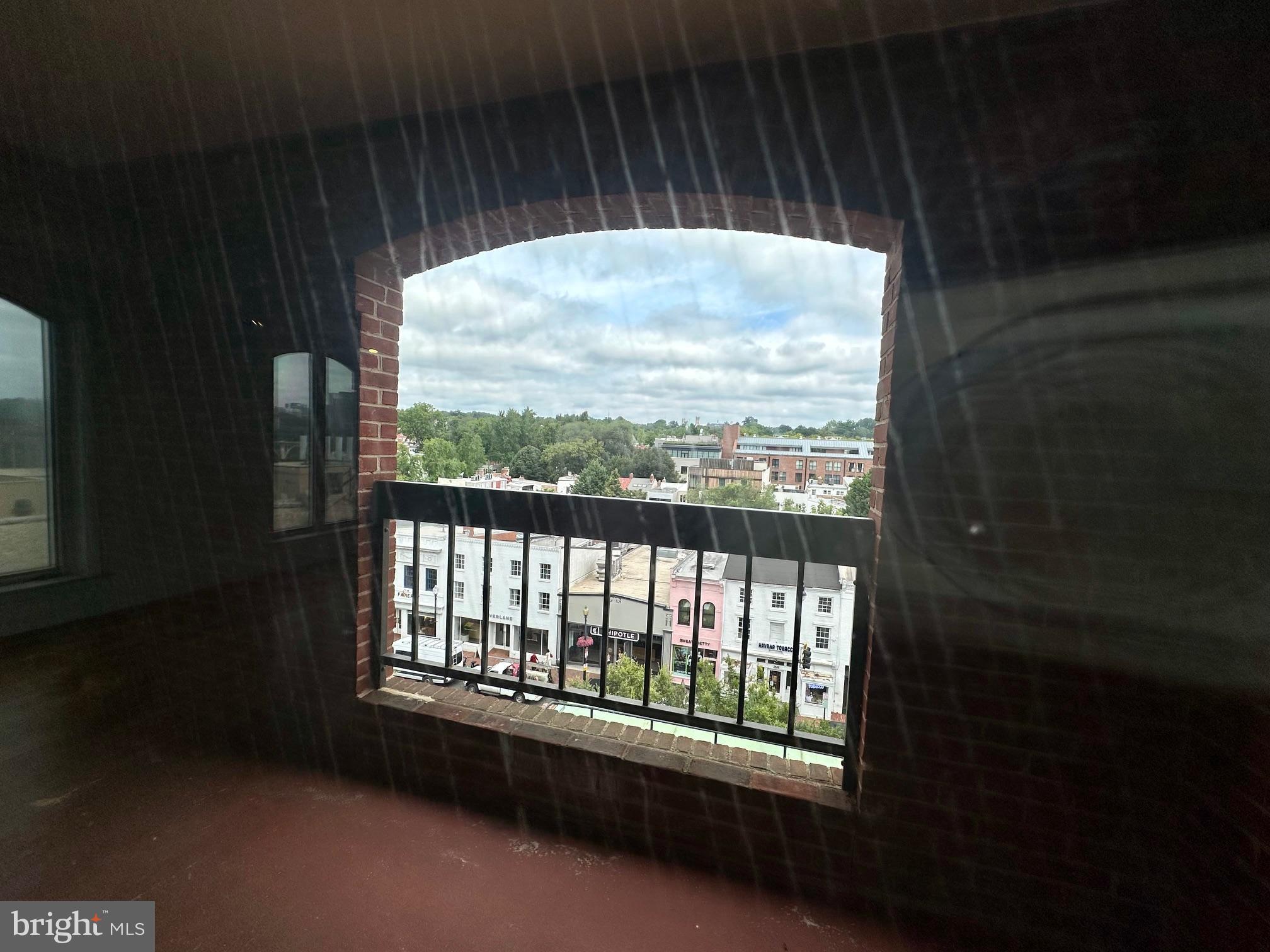 1080 Wisconsin Avenue Northwest, Unit 503W Washington, DC 20007 - Photo 20 of 36 a view of an empty room with a window