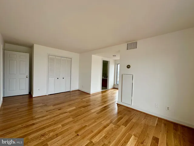 a bathroom with a granite countertop sink a toilet and a mirror
