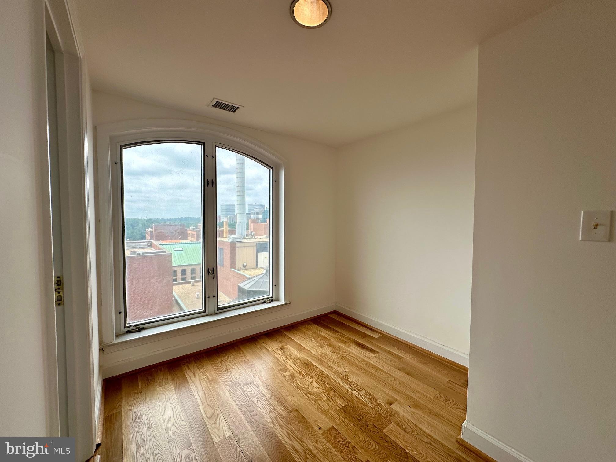 1080 Wisconsin Avenue Northwest, Unit 503W Washington, DC 20007 - Photo 28 of 36 a view of empty room with wooden floor and fan