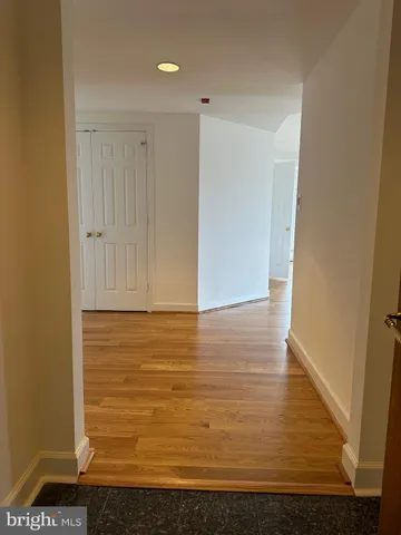 a view of a hallway with wooden floor