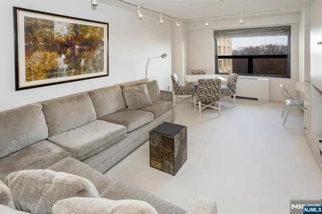 a living room with furniture and a large mirror