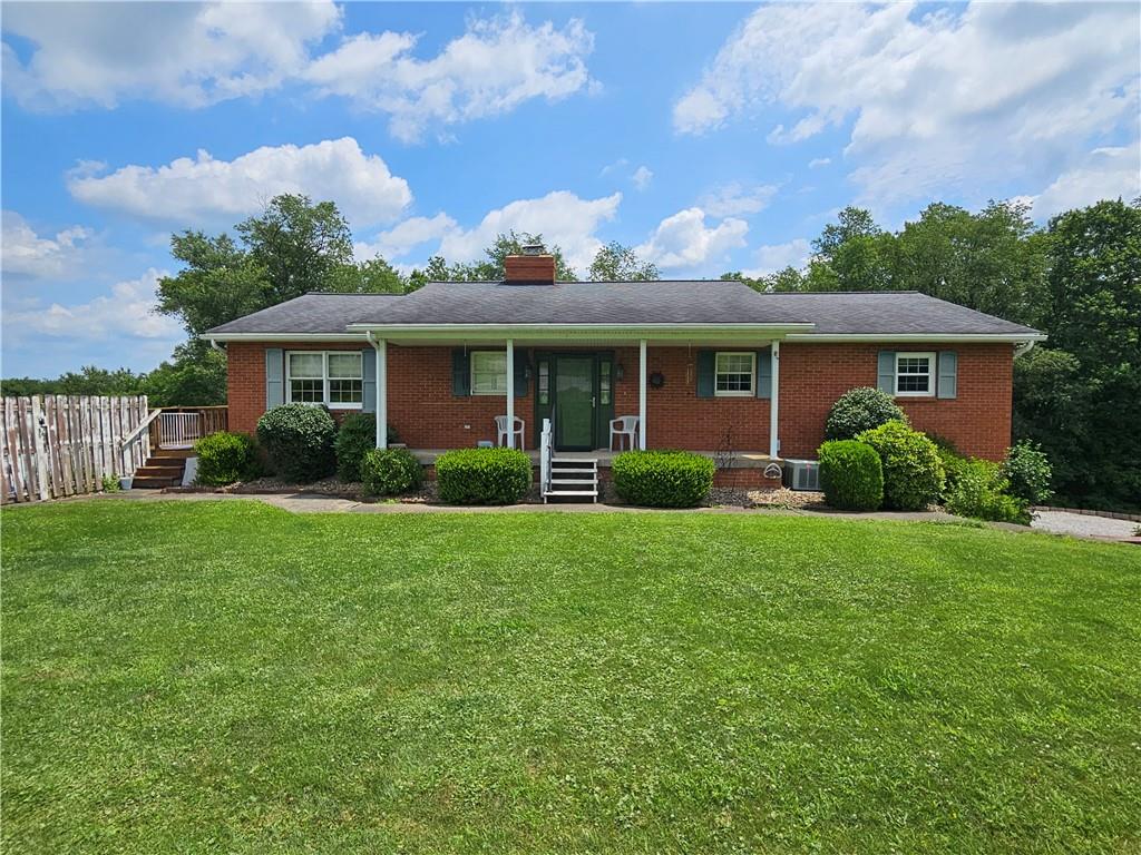 a front view of house with yard and green space