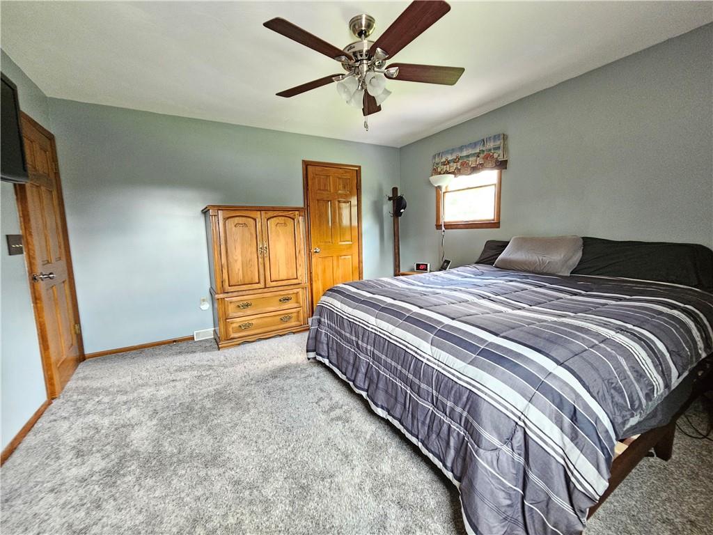 323 Hoon Road Butler, PA 16001 - Photo 12 of 49 a bedroom with a bed and a chandelier