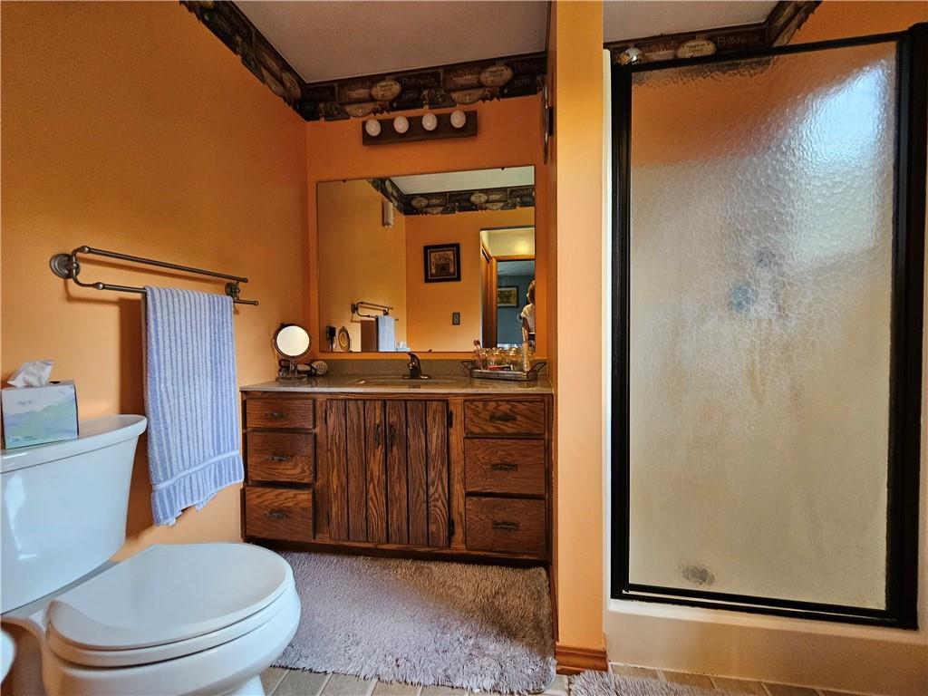 323 Hoon Road Butler, PA 16001 - Photo 15 of 49 a bathroom with a toilet a sink and a mirror