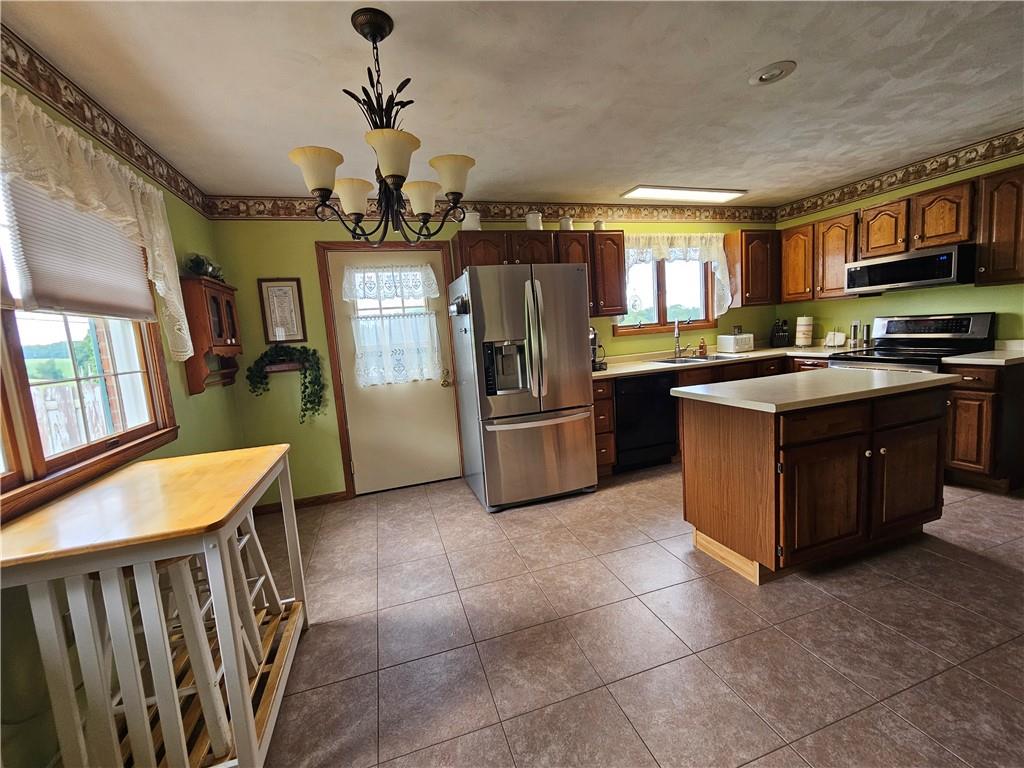 323 Hoon Road Butler, PA 16001 - Photo 33 of 49 a kitchen with stainless steel appliances granite countertop a stove and a refrigerator